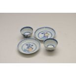 A pair of Nanking cargo miniature blue and white Chinese porcelain tea bowls and saucers, the