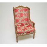 An early 20th century French gilt armchair, the carved frame decorated with acanthus mounts,