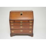 A 19th century oak bureau, with a fitted interior above an arrangement of six drawers, with brass