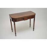 A 19th century mahogany fold-over tea table, with strung borders, raised on turned legs, 75cm