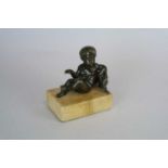 A small 19th century bronze study of a recumbant cherub with eagle, on a marble base, 11.5cm high,