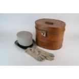 A scumbled tin hat box containing a grey Moss Bros top hat, size 6 7/8, together with a pair of