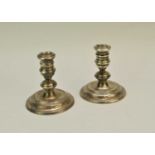 A pair of short silver mounted candlesticks