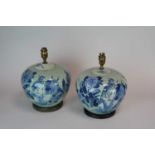 A decorative pair of blue and white desk lamps, hand-painted with birds and foliage in the Chinese