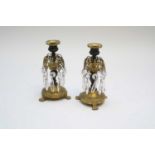 A pair of late 19th century French bronze and gilt metal candlesticks, decorated with hanging