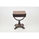 A small 19th century mahogany card table, with a slide folding top, over a carved stem and