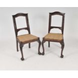 A set of six mahogany dining chairs, with scrolling shallow carved backs, the swept claw and ball