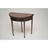 A demi-lune mahogany card table, 76 cm high, 84 x 42cm.