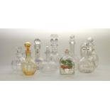 An interesting selection of glass decanters, including a wrythen amber moulded example, cut, press-