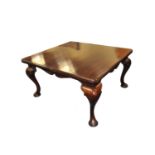 A heavy Victorian mahogany dining table, the extending top over heavy swept legs terminating in