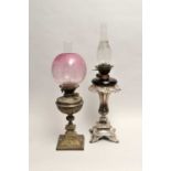 A Victorian electroplated lamp stand, accommodating a ruby glass oil lamp, with clear glass chimney,