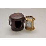 A miniature cased brass carriage clock, of oval form, the white enamel dial with black Roman