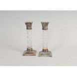 A pair of silver mounted glass candlesticks