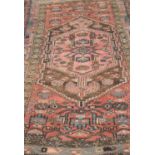 A small Eastern woven wool rug, with central geometric medallion flanked by further devices and