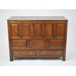 An 18th century oak mule chest, the 4-section top above five portrait fielded panels, over three