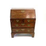 A George III mahogany bureau, the fall front above two short and two long drawers, raised on bracket