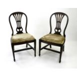 Four upholstered mahogany side chairs, the arched backs with moulded vase splats, the seats with
