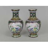 A pair of Chinese Canton enamel vases, Republic period, of baluster form and decorated with scenes