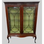 An Edwardian inlaid mahogany display cabinet, the ogee cornice with Gothic moulding above twin