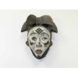 A Punu carved and painted wood tribal mask, Gabon, Central Africa, of classical form