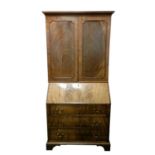 A George III mahogany bureau bookcase, the possibly associated upper section with ogee cornice above