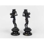 A pair of bronze figural candlesticks, probably French, circa 1900, each modelled as a putto