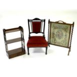An ebonised upholstered nursery chair with red velvet fabric, an Edwardian mahogany mural shelf with