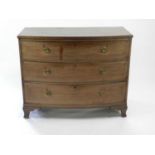 A 19th century mahogany veneered bowfronted chest of three long drawers, some damage and faded