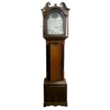 A George III oak and mahogany crossbanded eight day longcase clock, with a 12" painted, arched dial,