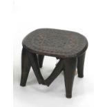 A vintage Nupe tribal stool, Central Africa, the ovoid seat raised on tapering supports, 23cm high.