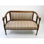 An Edwardian upholstered inlaid mahogany salon suite, comprising two-seater sofa and a pair of