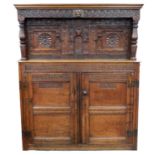 A 17th century and later oak court cupboard, the upper rail on the upper section carved ‘1686’,