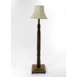 A late Victorian mahogany standard lamp, with carved and spiral fluted column set on a stepped