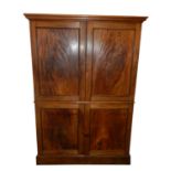 A George III mahogany linen press, the moulded top above twin panelled doors opening to four