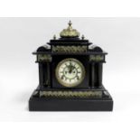 An Ansonia black slate mantel clock, of architectural form with brass cast mounts, the eight day