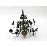 A Continental style brass chandelier, with multiple branches cast with fish issuing from a ball-