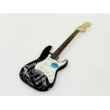 A Fender Squire Stratocaster electric guitar, in black with white finger plate, printed with Jack