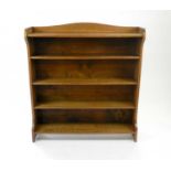 An Edwardian joined oak open bookcase, 110cm wide, 120cm high, 25cm deep.