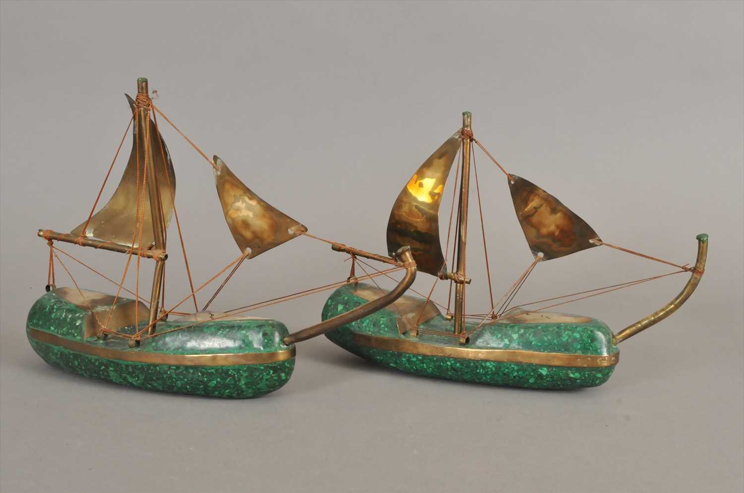 A pair of African folk art models of boats made from malachite and brass