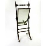 A late Victorian mahogany cheval mirror, the rectangular plate within turned supports, raised on