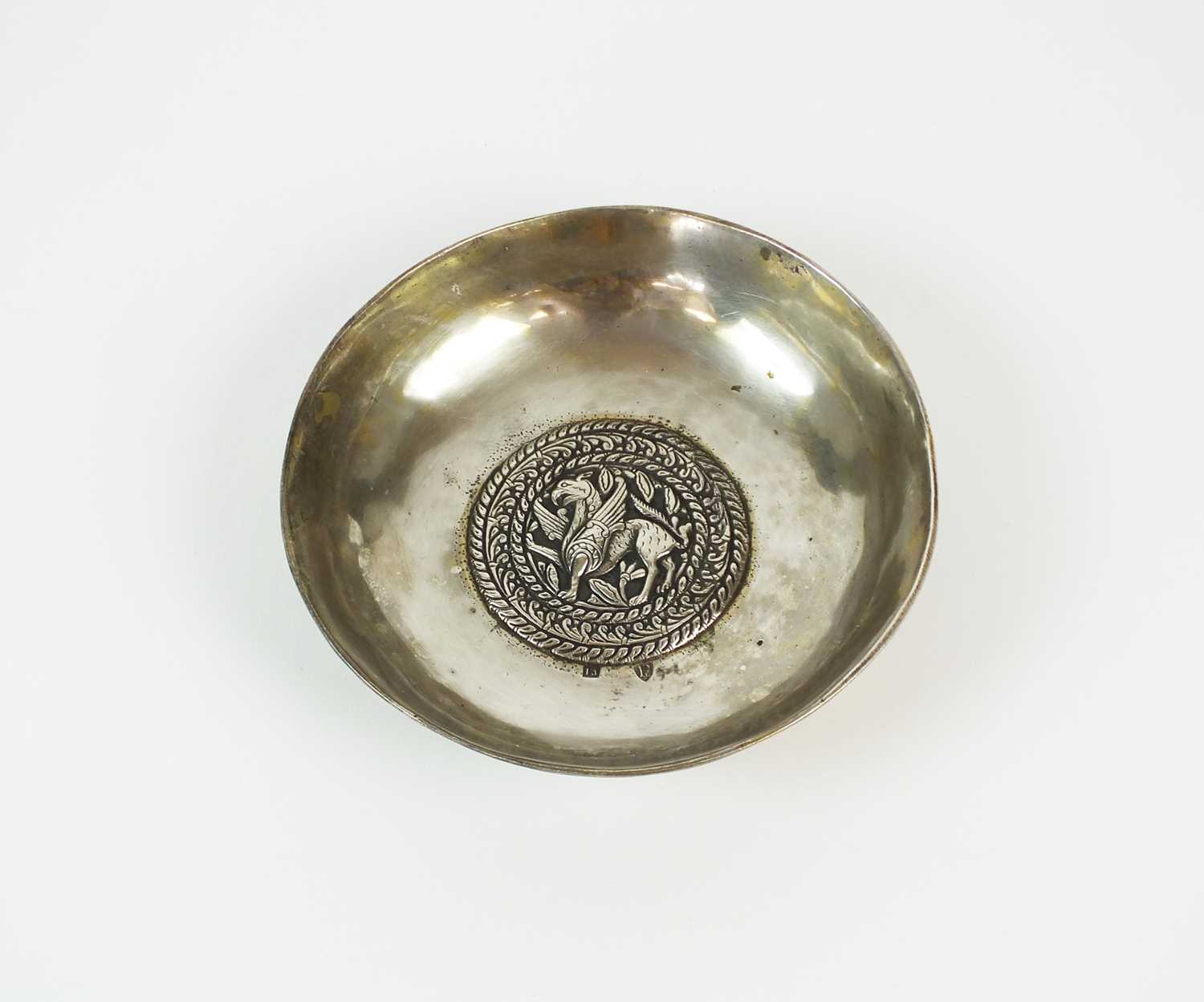 A continental white metal wine taster/bowl