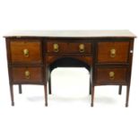 An early 19th century oak and mahogany crossbanded, serpentine sideboard, all drawers inlaid with