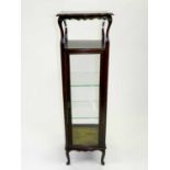 An Edwardian mahogany glazed display cabinet, of square section, 36cm wide x 137cm high.