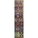 A collection of 20th century middle eastern rugs, including part of a caucasian rug, a/f, holed