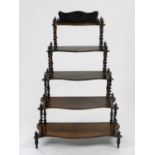 A Victorian rosewood whatnot, of waterfall form, the shaped shelves on barley twist supports, 80cm