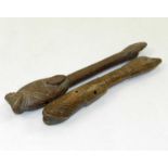 Two carved wood tribal whistles, Mossi, West Africa, of club form with incised patterns