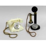 A GPO model 150 'candlestick' rotary telephone and a cream coloured model 232 'pyramid'