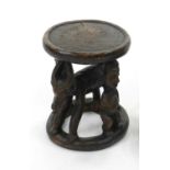 A vintage Bamileke tribal stool, Cameroon, West Africa, the circular top raised on carved supports