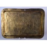 AN EARLY 20TH CENTURY ISLAMIC BRASS TRAY, rectangular in form and decorated with calligraphy. 27 cm