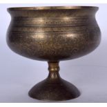 AN EARLY 20TH CENTURY ISLAMIC BRASS PEDESTAL BOWL, engraved with extensive foliage. 16.5 cm x 17 cm.